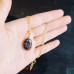 Goldstone mixed color oval pendant with a gold tone chain