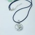 Om Silver Plexus pendant with a black cord